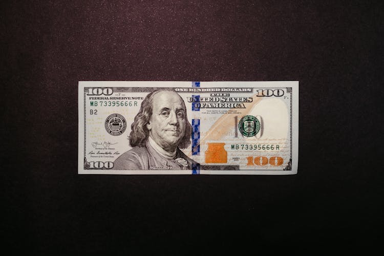 One Hundred Dollar Bill On Black Background