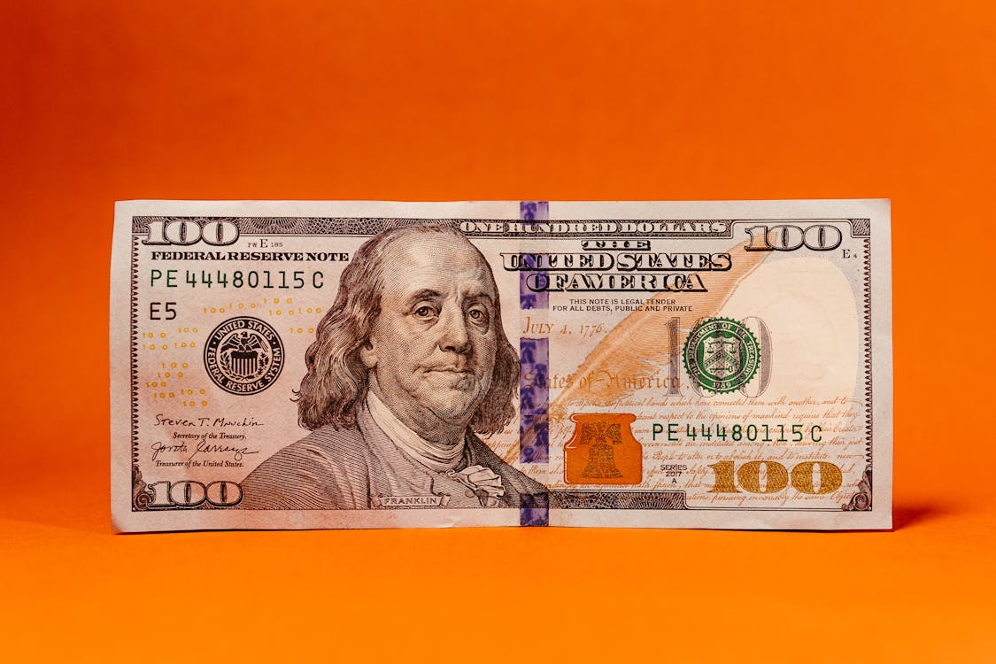 Close-up of a One Hundred Dollar Bill with an Orange Background · Free Stock Photo close-up-of-a-one-hundred-dollar-bill-with-an-orange-background-free-stock-photo