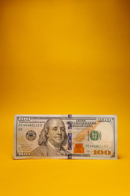 A Dollar Bill on Yellow Background