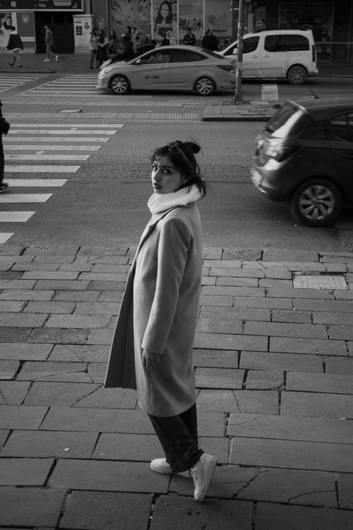 Free Stylish woman in a coat on a city sidewalk in Ankara, Turkey. Stock Photo