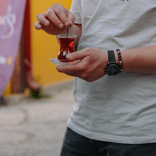 Man Holding a Glass of Turkish Tea