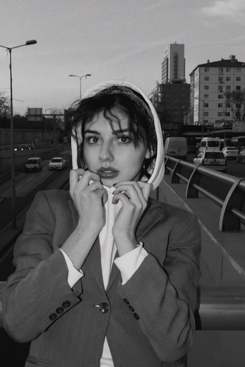 Free Young Woman Standing on a Footbridge above the Street Stock Photo