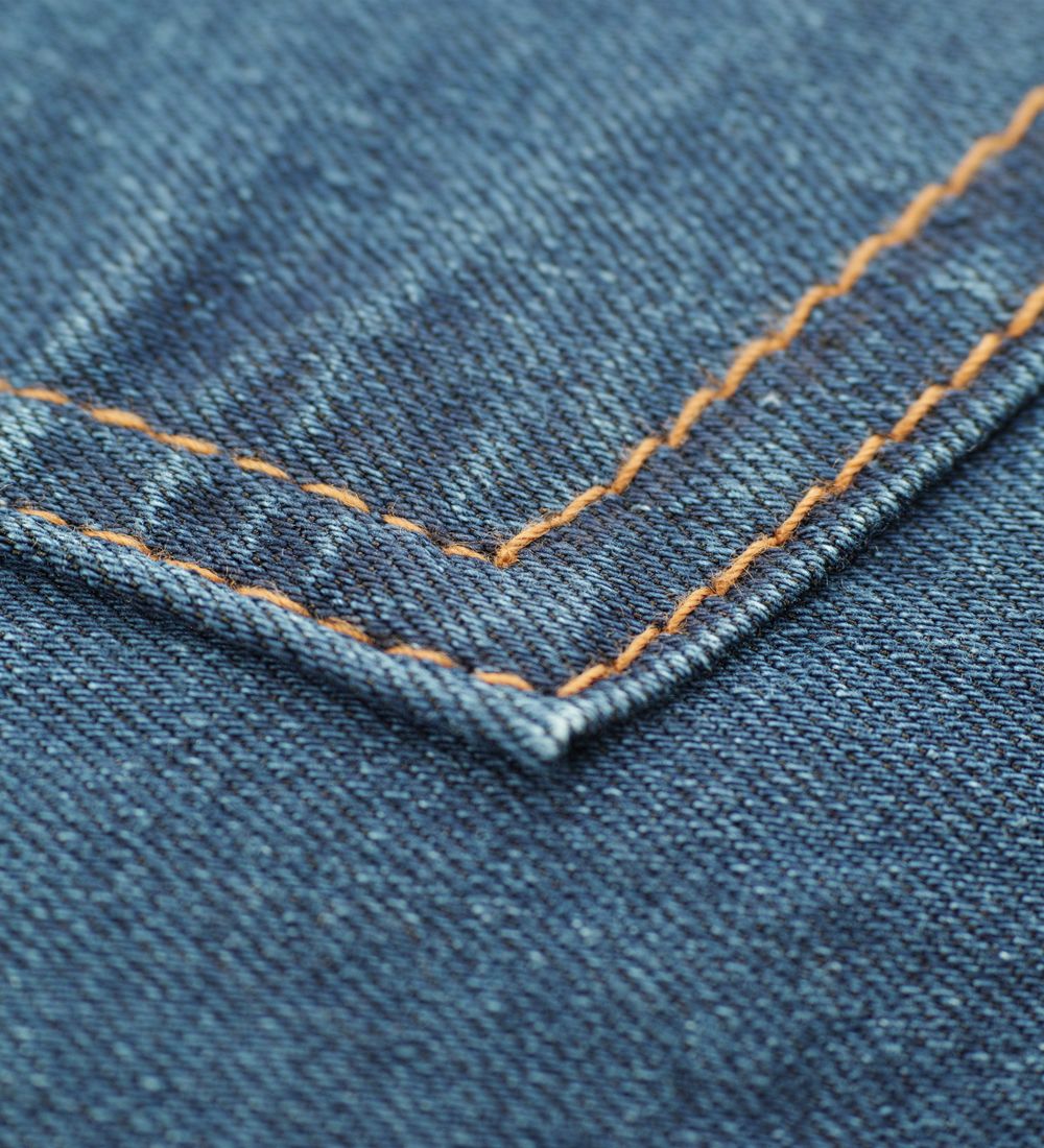 Macro photograph of precision stitching on performance fabric