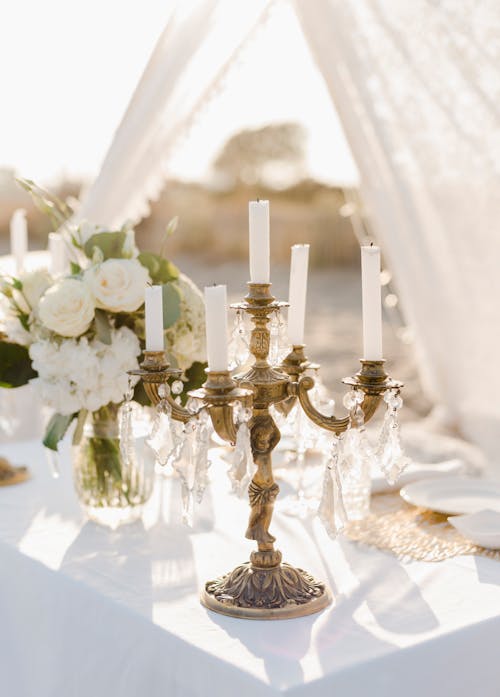Elegant Candle Holders and White Bouquet in a Vase