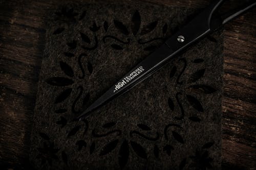 A Pair of Black Scissors on Brown Wooden Surface
