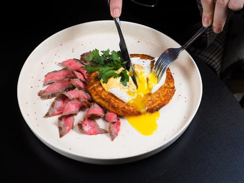 Free Person Cutting Food on a Plate  Stock Photo