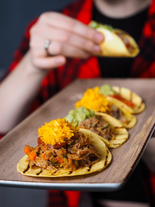 Person Holding a Tray with Mexican Tacos