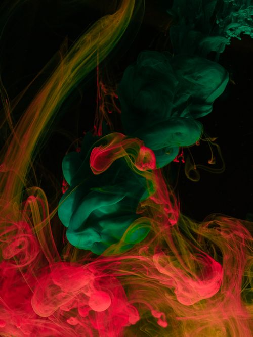 Free A stunning close-up of colorful ink swirling in water, perfect for vibrant and abstract art projects. Stock Photo