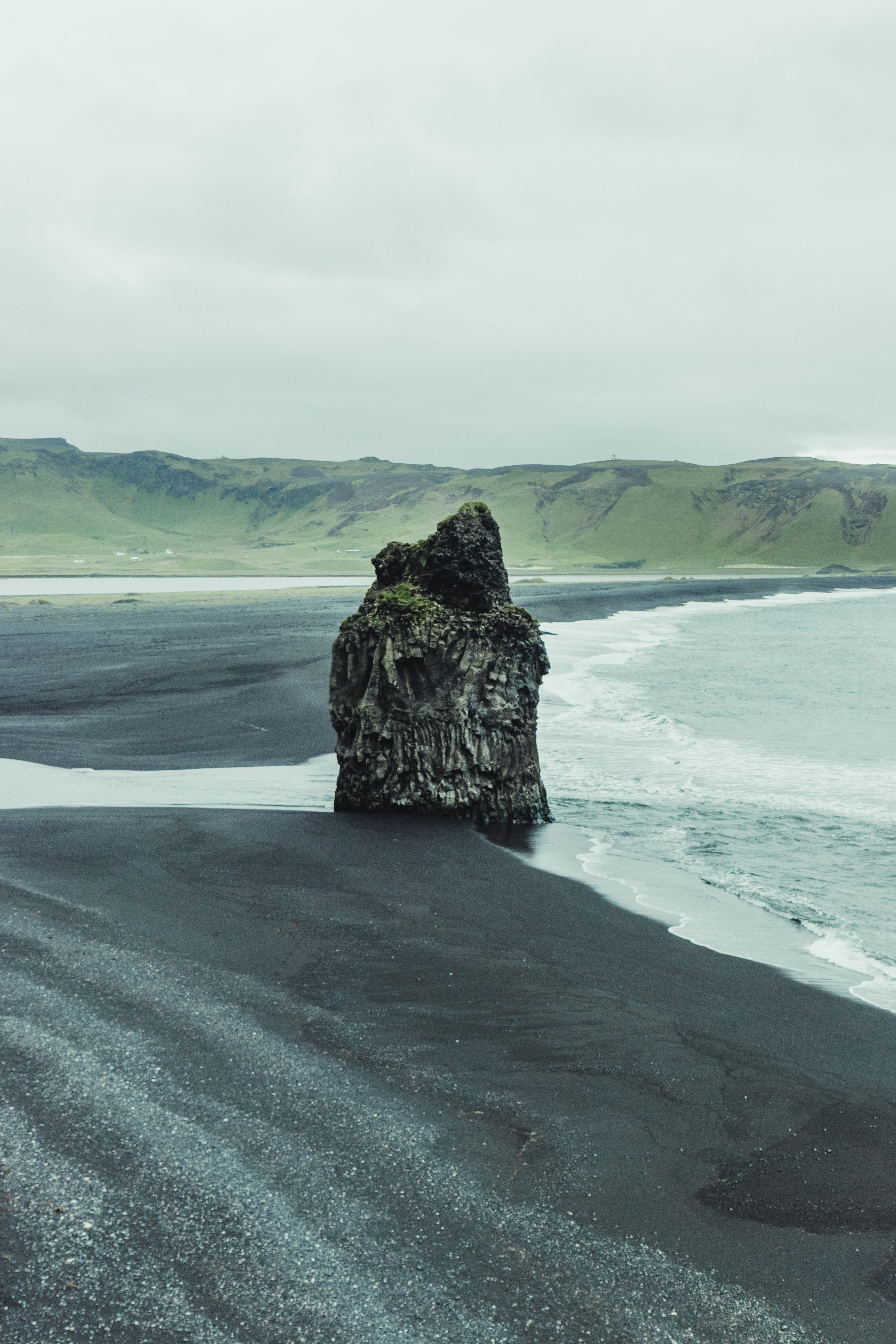 Basalt Sitting Rocks Couple Sitting on Basalt Rock Formation on Reynisfjara Beach in Iceland ...