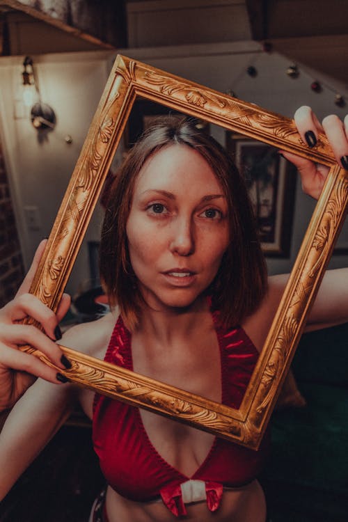 A Woman Holding a Frame 