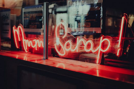 Artistic neon sign with warm glow in an intimate restaurant atmosphere. Perfect for food and nightlife visuals.