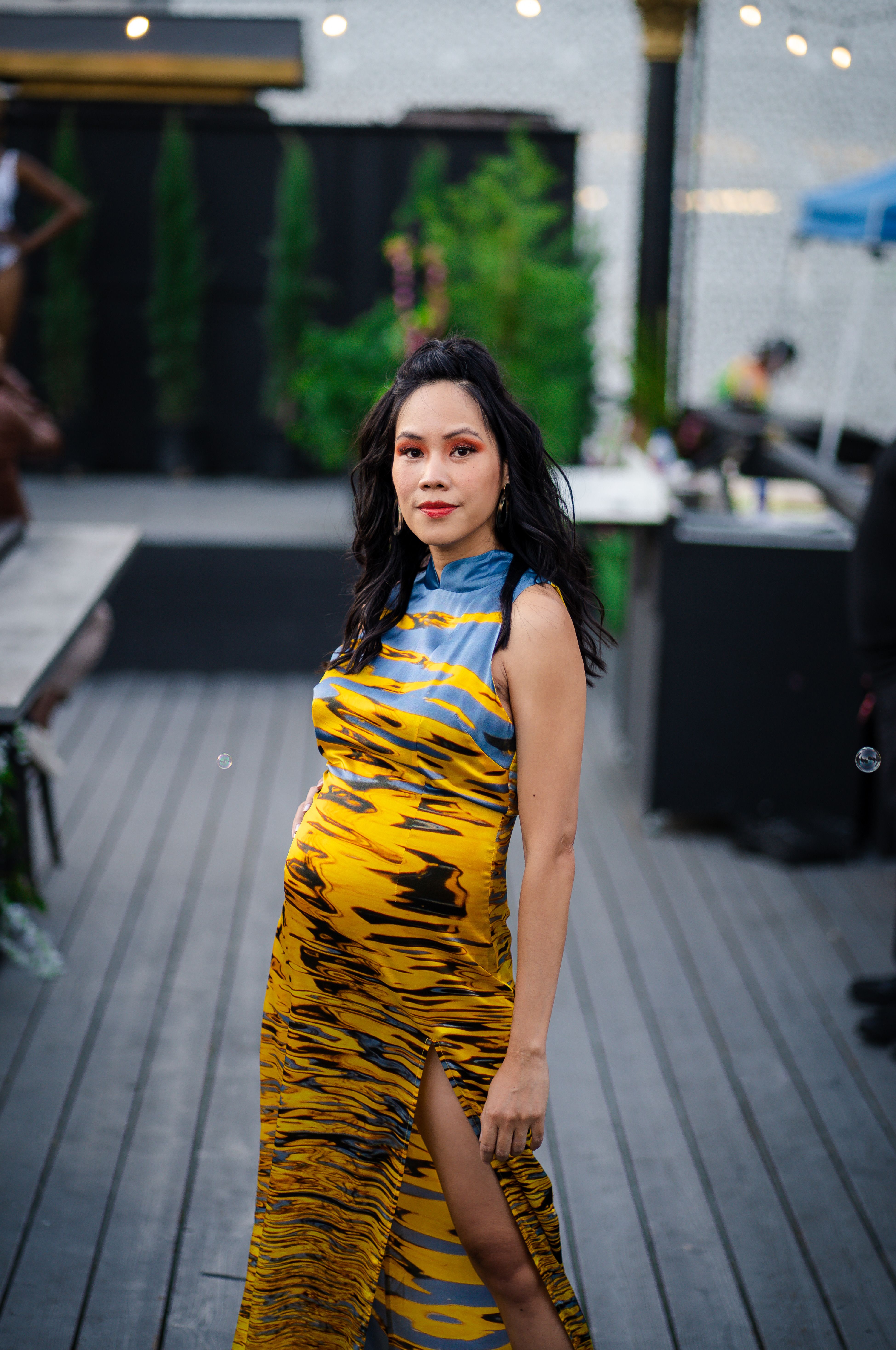 Beautiful woman posing outdoors in a vibrant dress, perfect for event photography.