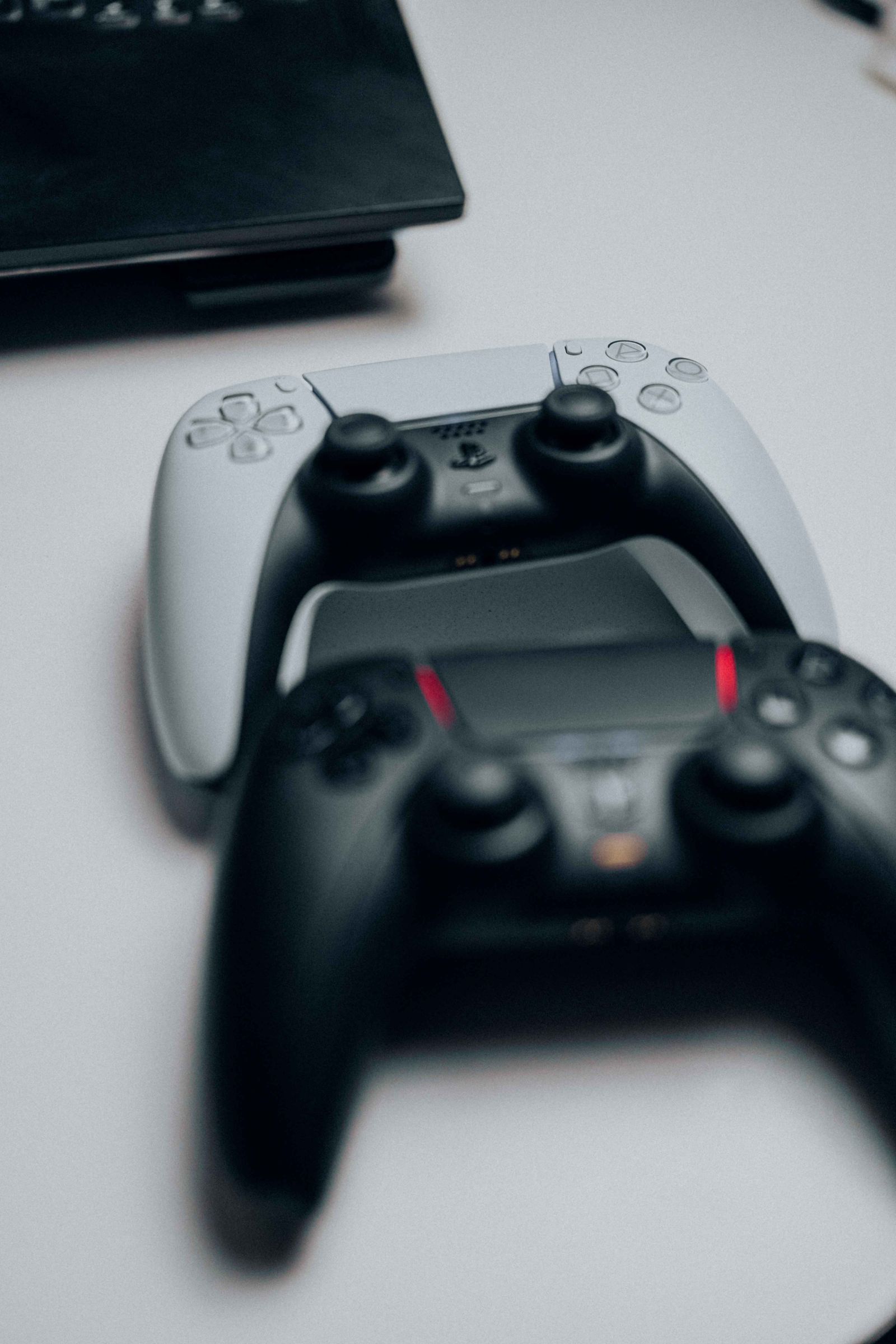 Modern game controllers arranged on a desk