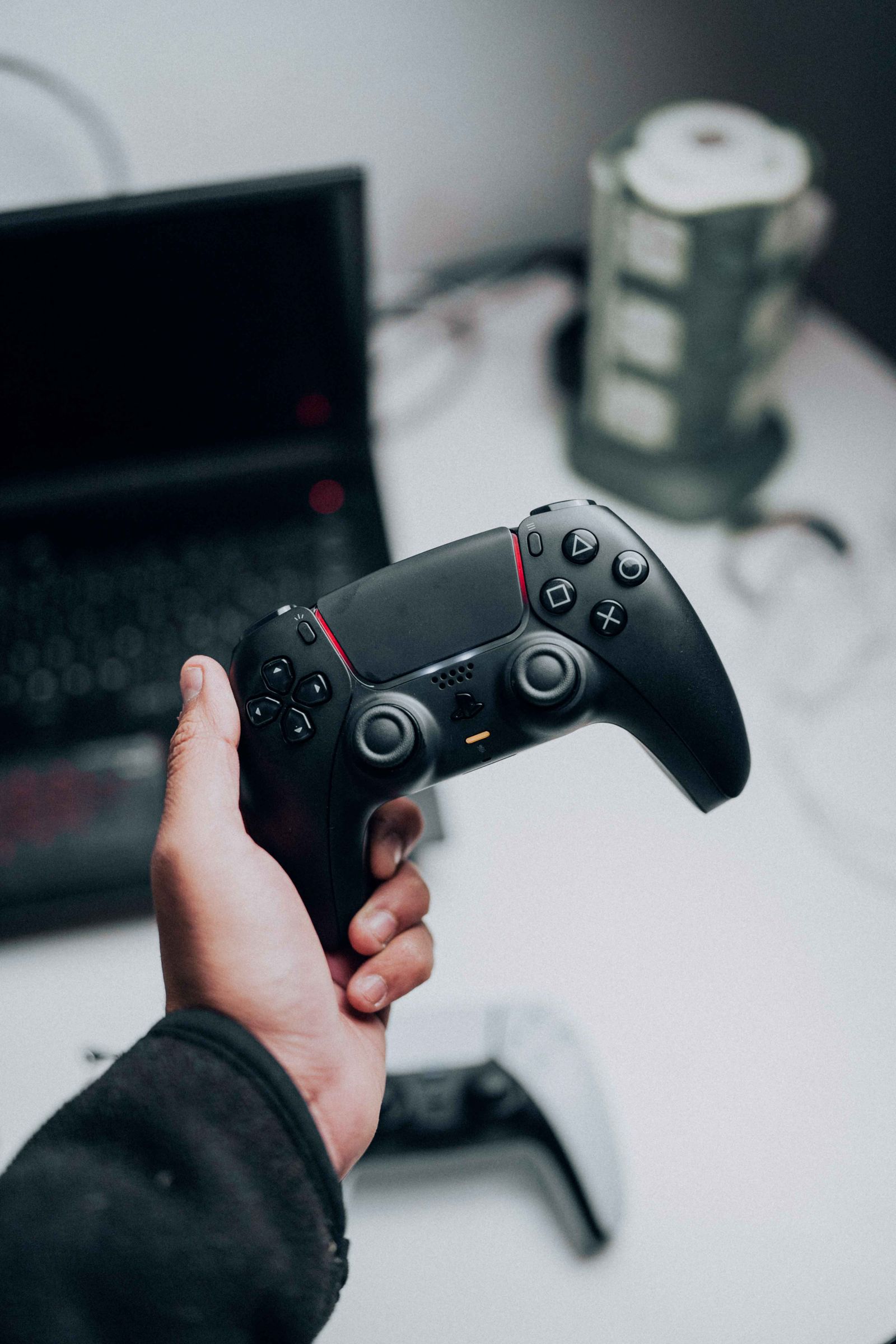 Game controller beside a laptop for interactive product testing