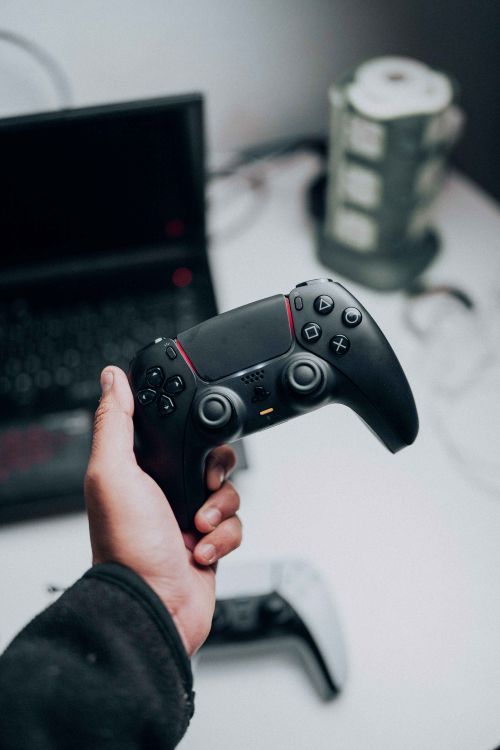 A Person Holding a Game Controller · Free Stock Photo