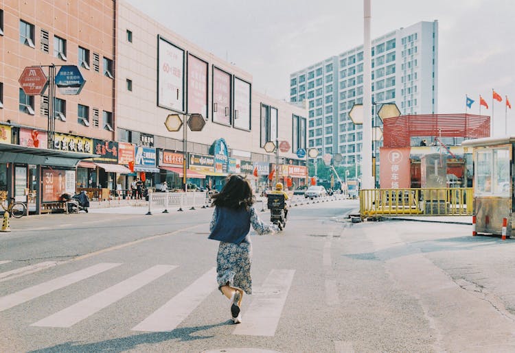 Back View Of A Woman Running In The Street