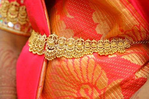Free Gold Jewelry over Orange Textile Stock Photo