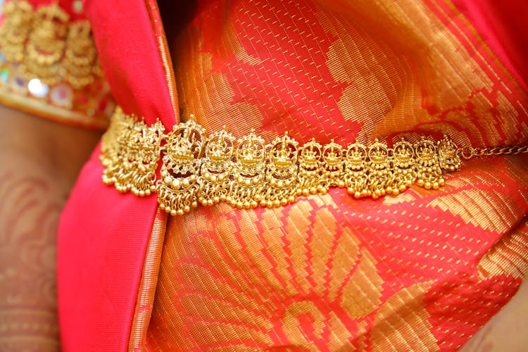 Gold Jewelry Over Orange Textile