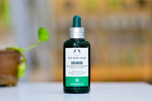 Close-up of Edelweiss serum bottle on a table with a blurred background.