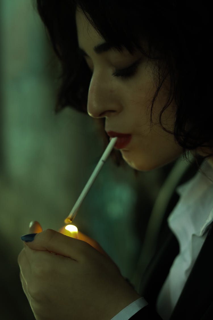 A Woman Lighting A Cigarette 