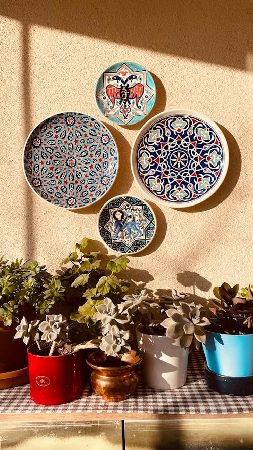 Colorful, Decorated Plates on Sunlit Wall