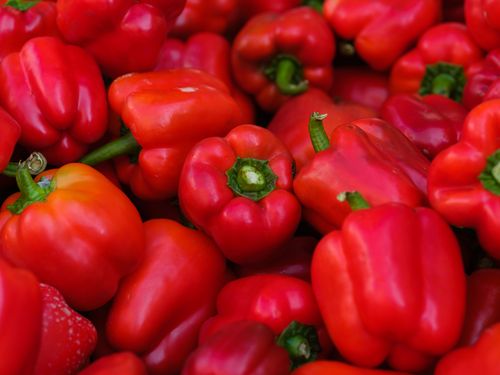 Free A close-up image of fresh red bell peppers with vibrant colors, ideal for food content. Stock Photo