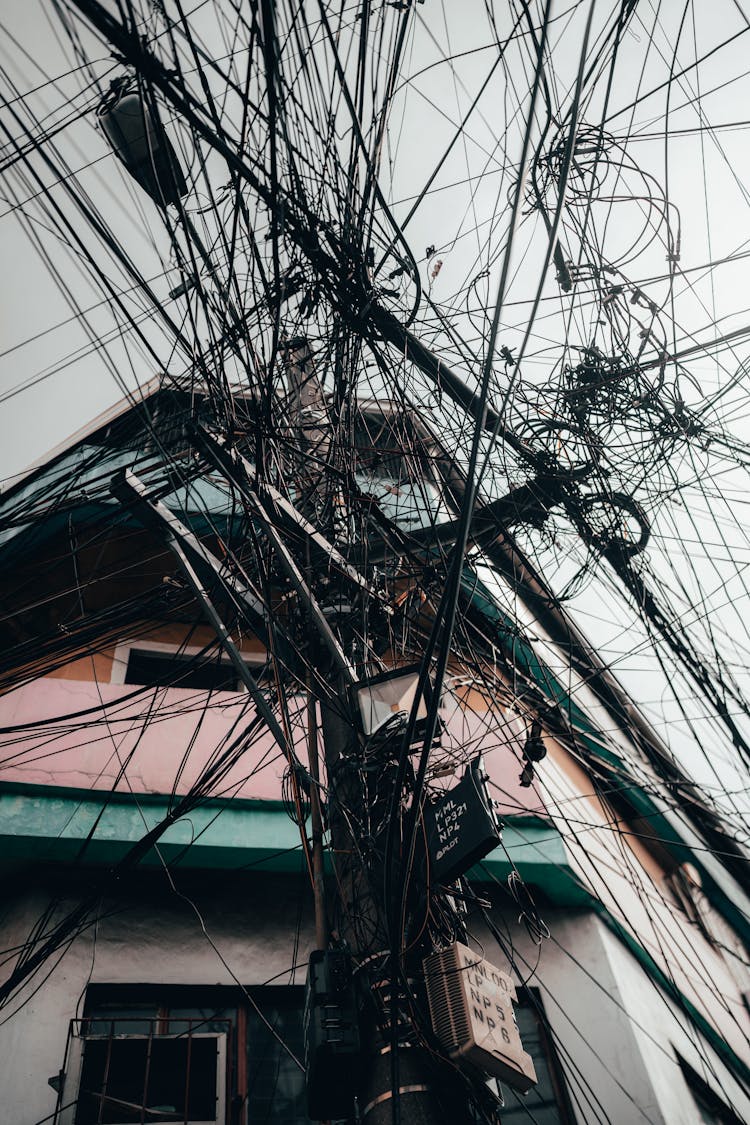 Electricity Lines On Pylon Near Building