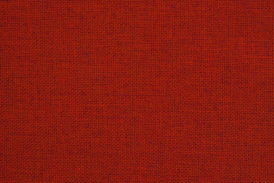 Close-up of red fabric texture showcasing woven textile pattern ideal for design.