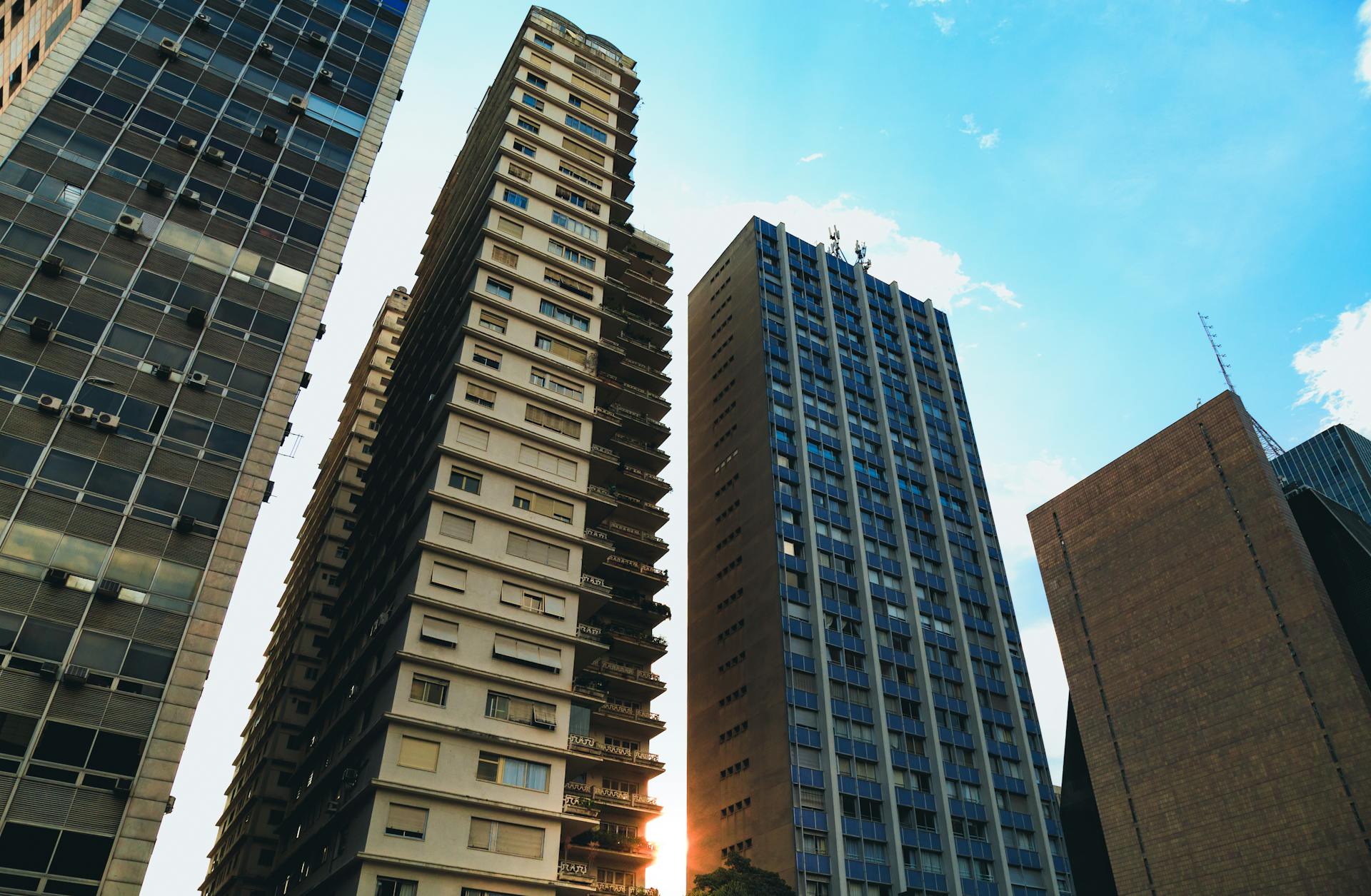 Experience the vibrant urban skyline of downtown São Paulo with towering skyscrapers under a clear blue sky.