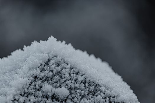A detailed macro shot of a frosty, icy surface captured in winter.