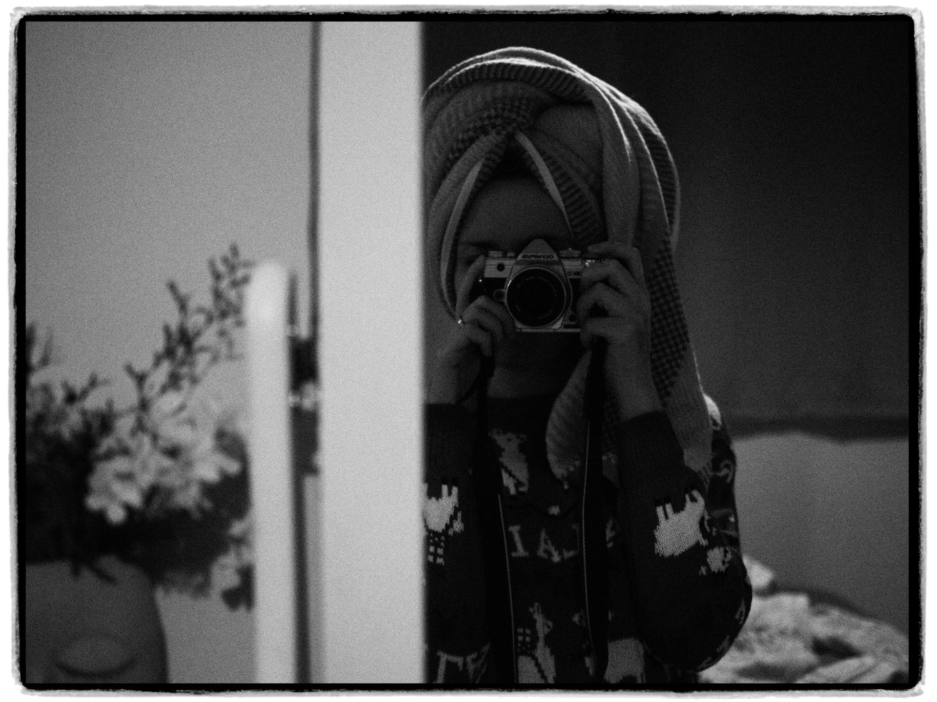 Woman with Towel on Head Taking Picture in Mirror