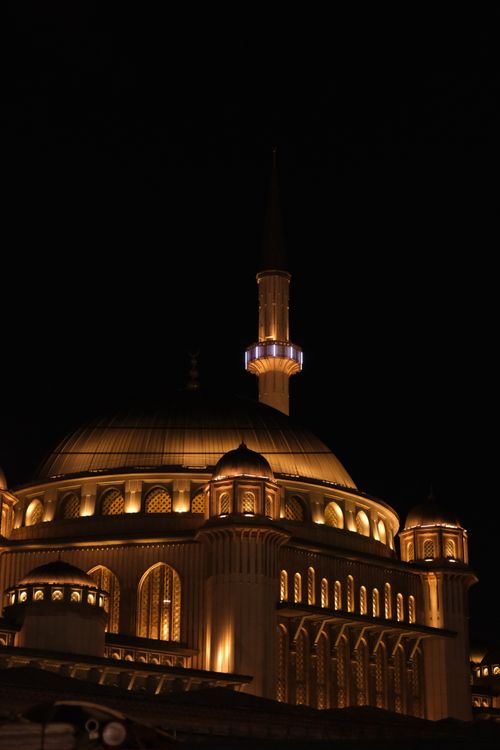 Free Spectacular night view of an illuminated mosque dome and minaret in Istanbul. Stock Photo