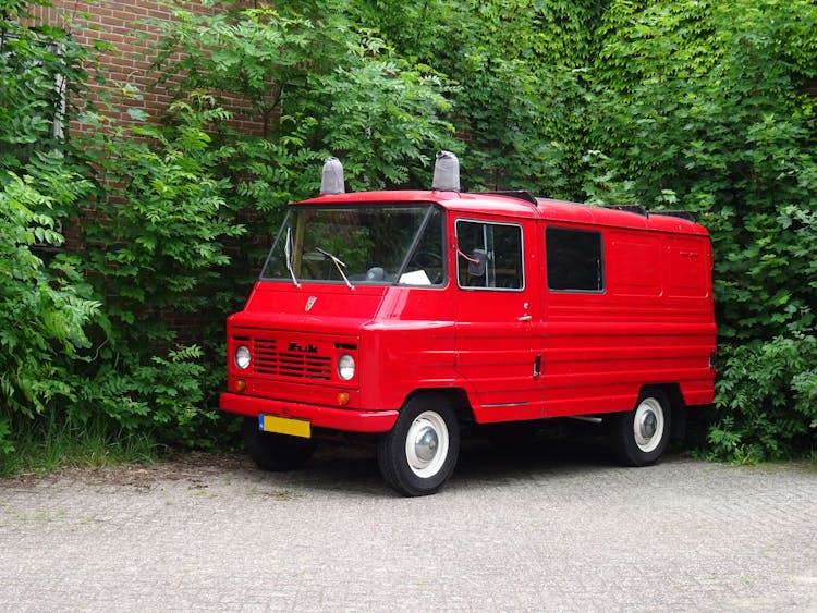 Red Truck Van Parked Beside Trees