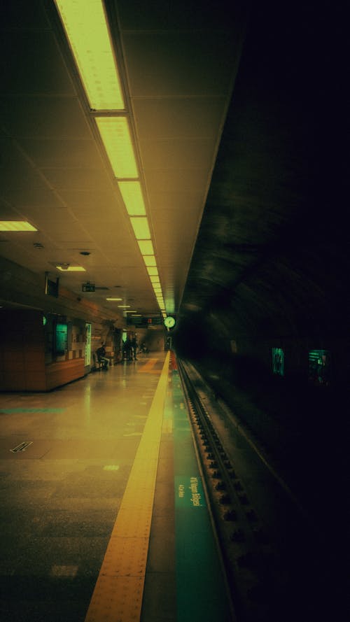 Symmetrical View of a Subway Platform and a Dark Tunnel 