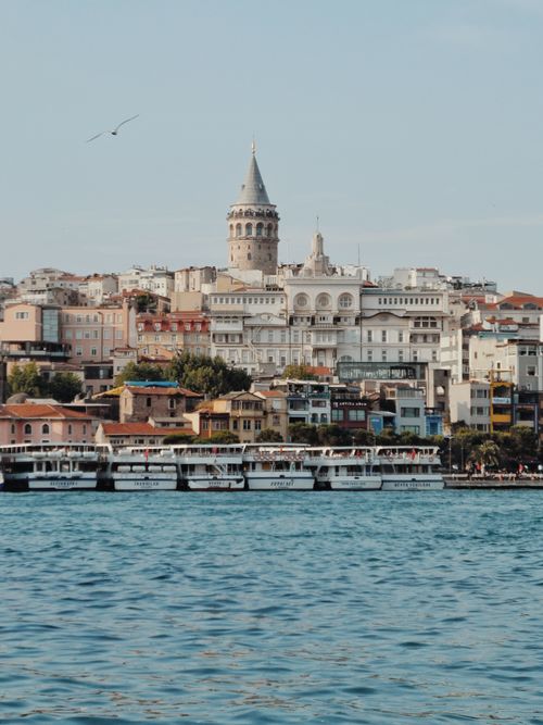 Free Scenic view of Galata Tower and Istanbul's vibrant waterfront with boats on the Bosphorus. Stock Photo