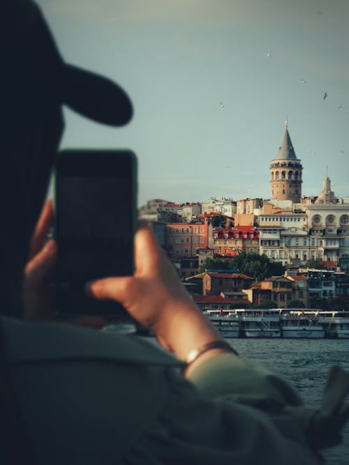 Person Taking Photo of Buildings with a Cellphone