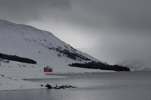 A Single Building on the Shore among Snowy Hills 