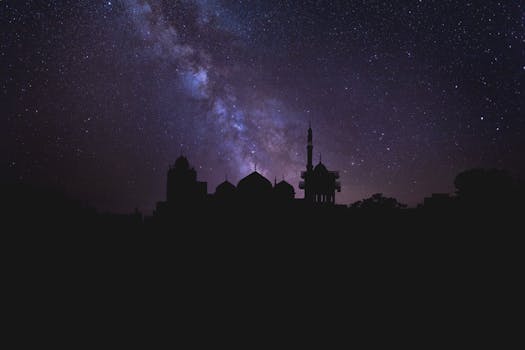 A breathtaking view of the Milky Way illuminating the night sky over a mosque silhouette in Lahore, Pakistan.