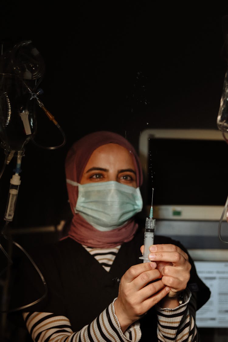 Nurse Holding Syringe In Hands