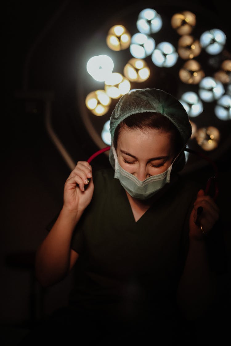 Nurse In Dark Operating Room