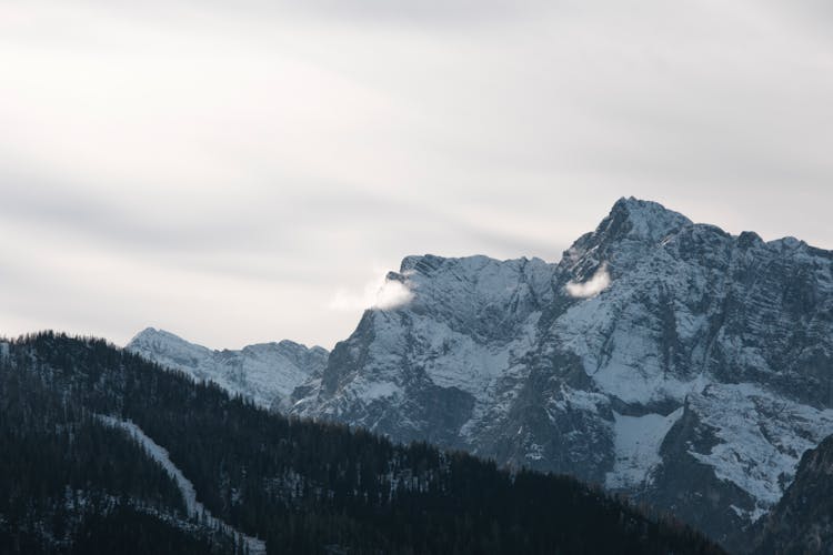 Mountains Peaks In Snow On Sky Background