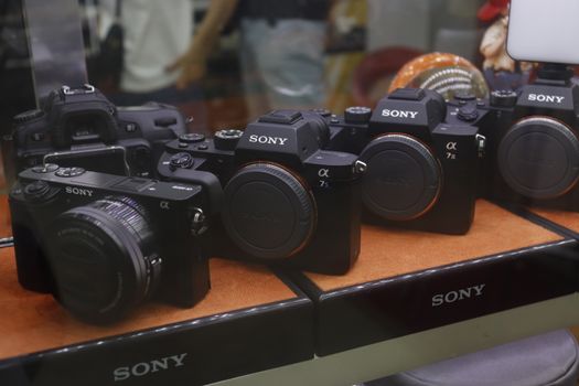 A collection of Sony digital cameras showcased in a store display case.