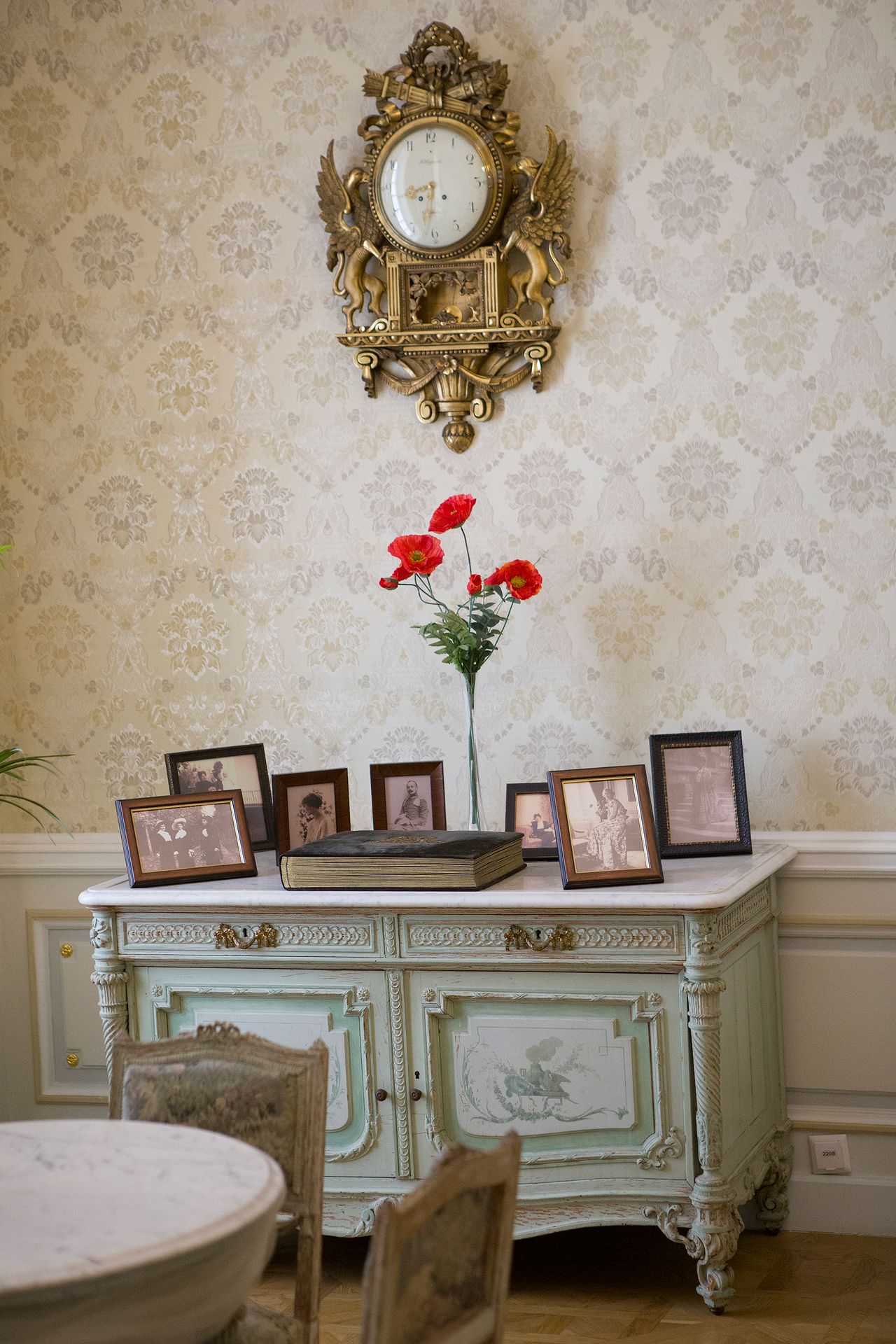 personalized-living-room-decor Vintage dresser styled with family photos, clock and flowers