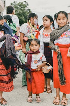 Children in traditional attire celebrating a cultural festival in Oaxaca, Mexico.