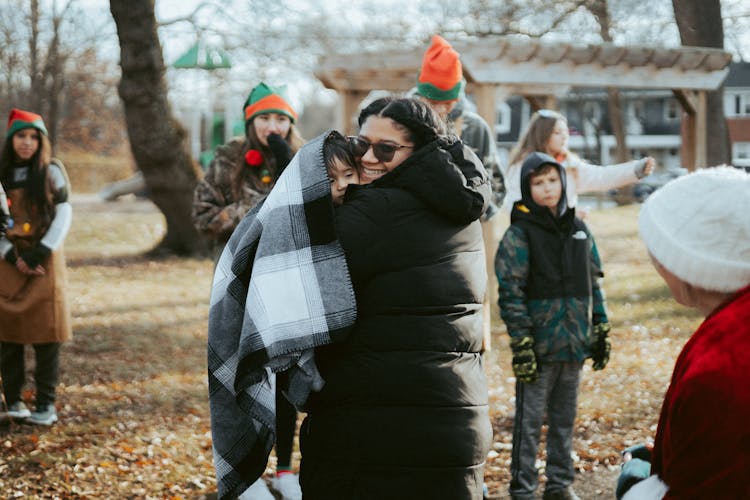 Mother With A Child On A Christmas Event In City 