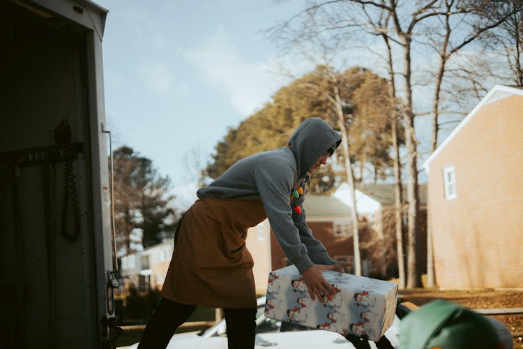 Volunteer Giving Away Christmas Presents In City