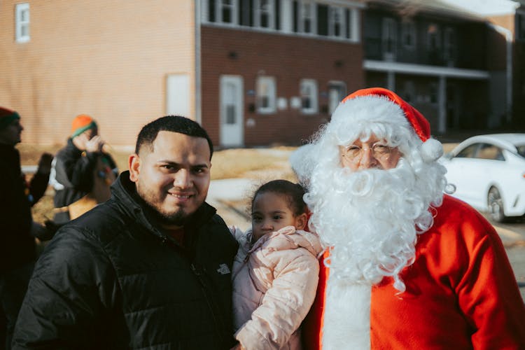 A Child With Her Father And Santa Claus 