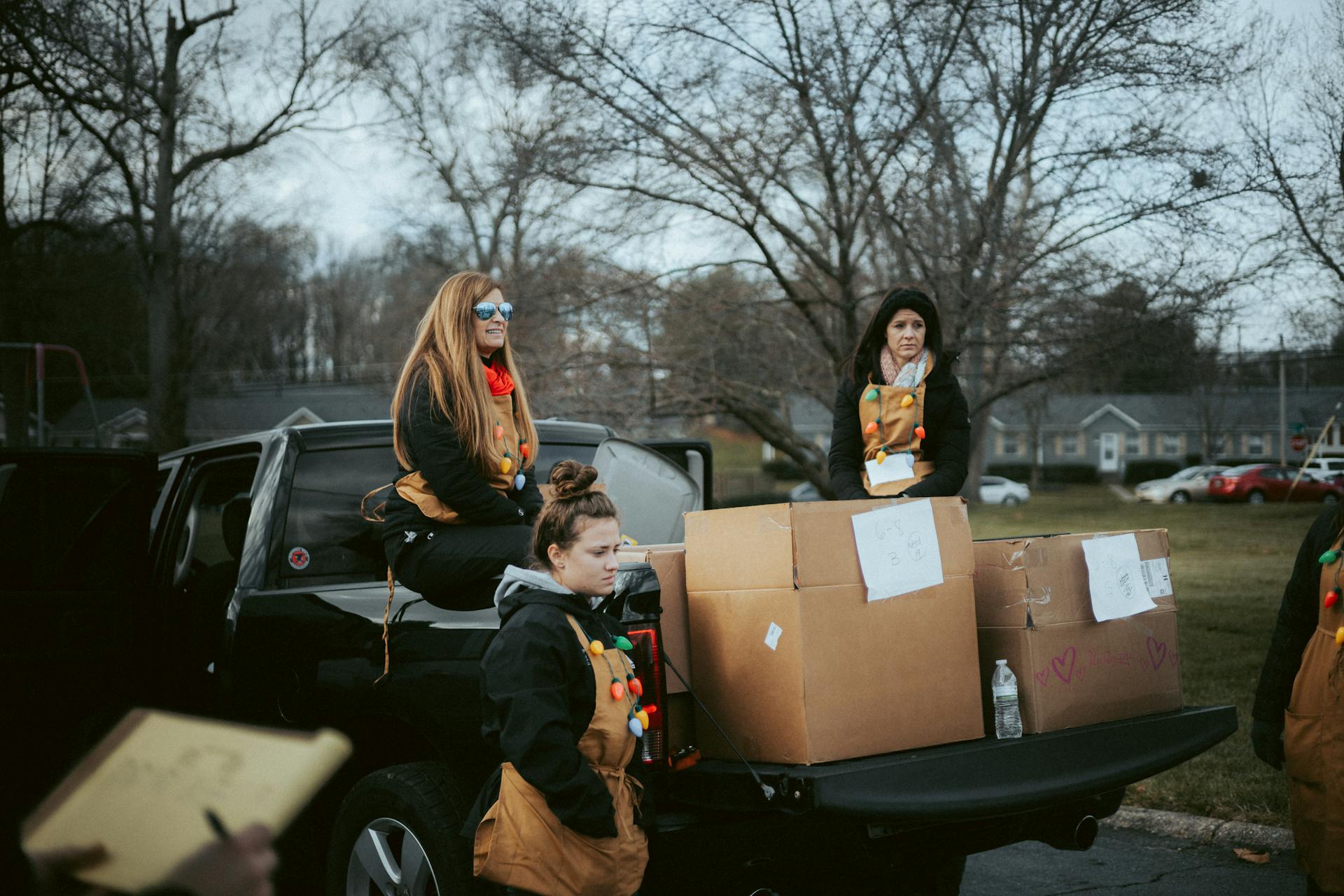 People in Christmas Costumes Giving Away Presents on a Christmas Event in City