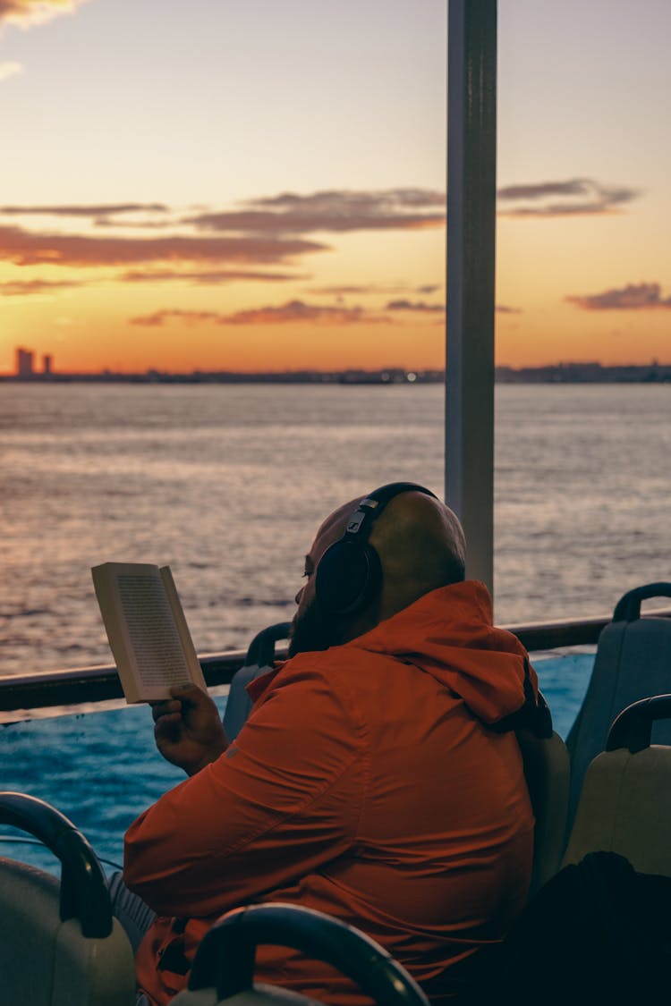 Man Reading Book On Ferry