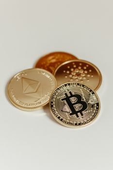 Elegant display of Bitcoin, Ethereum, and Cardano coins on a neutral background. 14832157